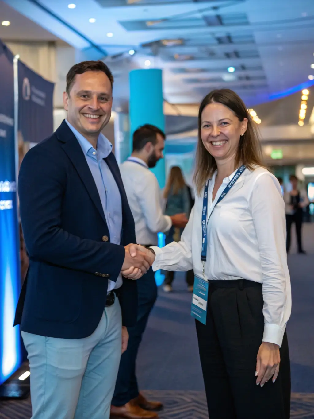 A photograph of a networking event at a food industry conference, showing professionals exchanging business cards and engaging in conversation.